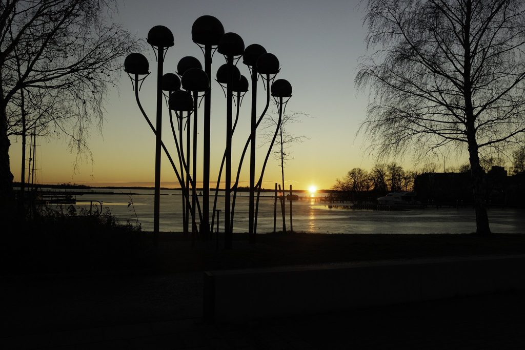 Solnedgång med skulpturer i förgrunden